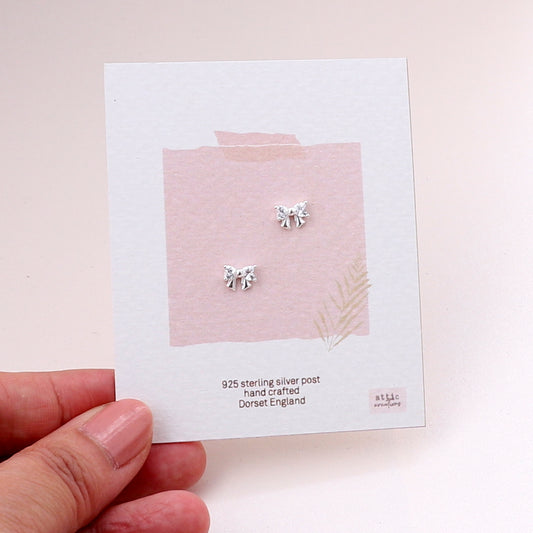 ME205 Silver crystal bow earrings
